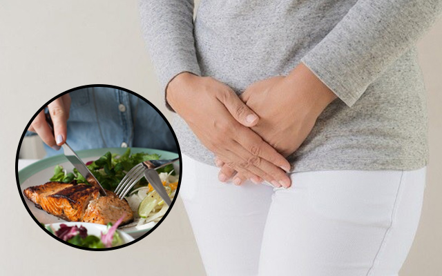 PCOS diet and abdominal discomfort concept with salmon meal highlighting anti-inflammatory nutrition for hormonal health